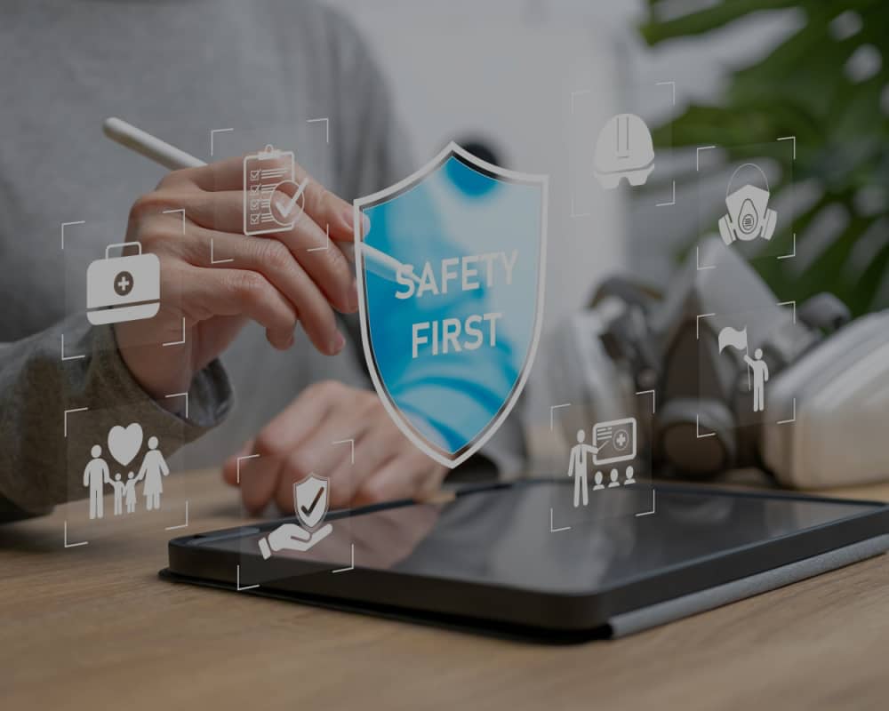 hand, pen, labtop, words safety first by Phase Associates